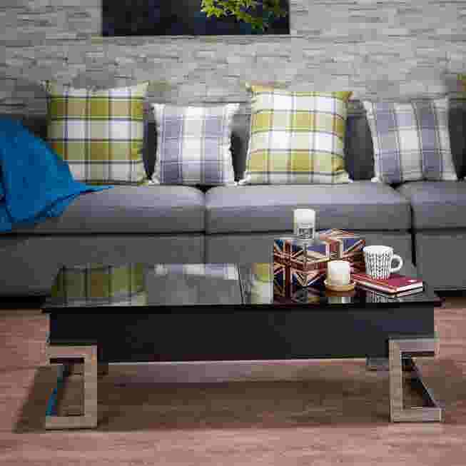 Black coffee table with lift top closed, holding items