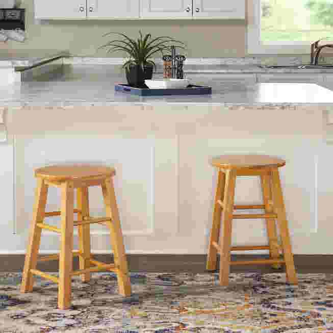Two wooden counter stools in a kitchen