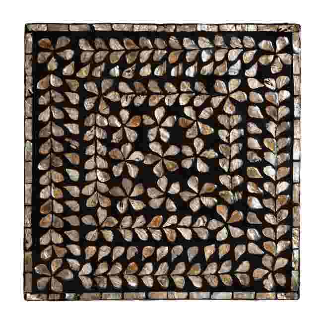 Top-down view of the mother of pearl inlay pattern on the end table.