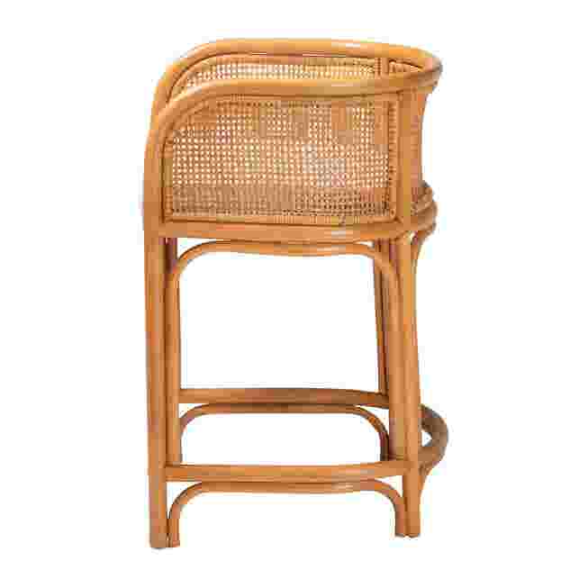 Side view of a natural rattan counter stool with white cushion