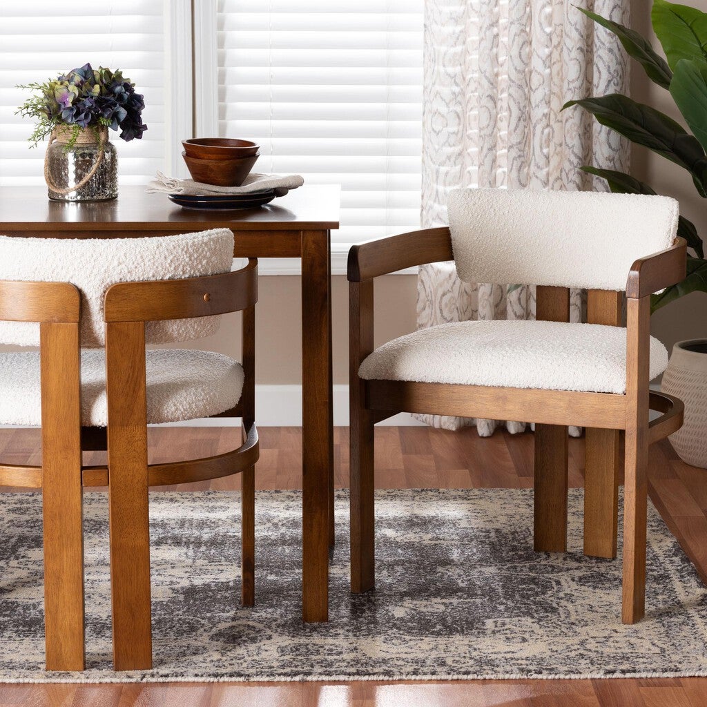 Cream boucle dining chair with wooden frame at a dining table
