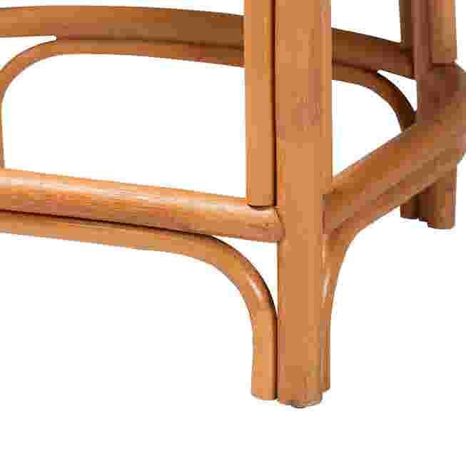 Close-up of the leg and footrest of a natural rattan counter stool