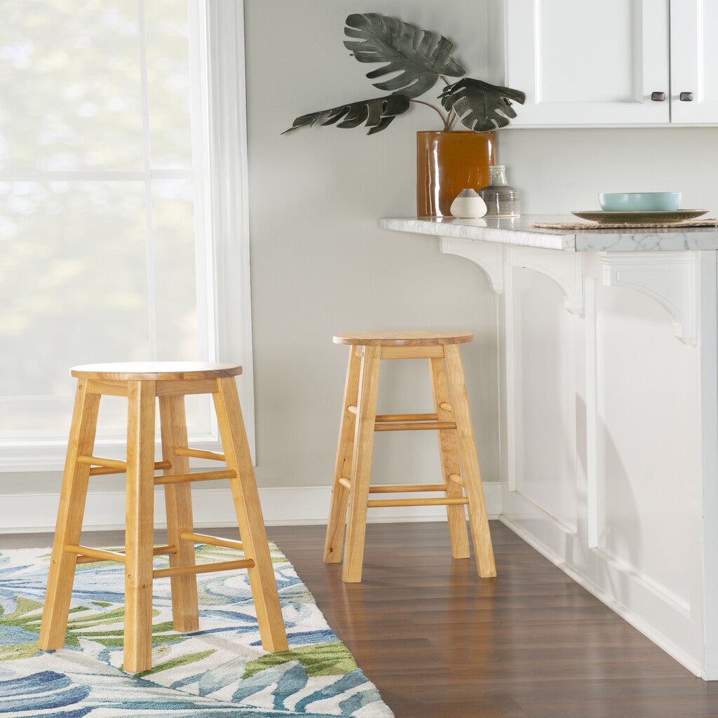 Two wooden stools in a kitchen island setting