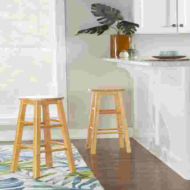 Two wooden counter stools in a kitchen