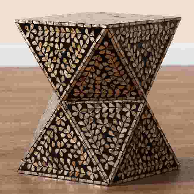 Modern bohemian end table with black and bronze mother of pearl inlay, shown from a side angle.