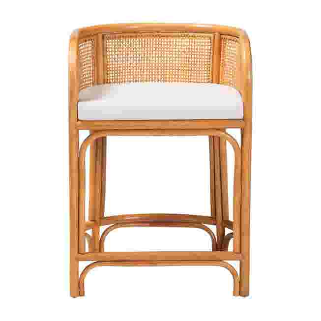Natural rattan counter stool with white cushion on a white background