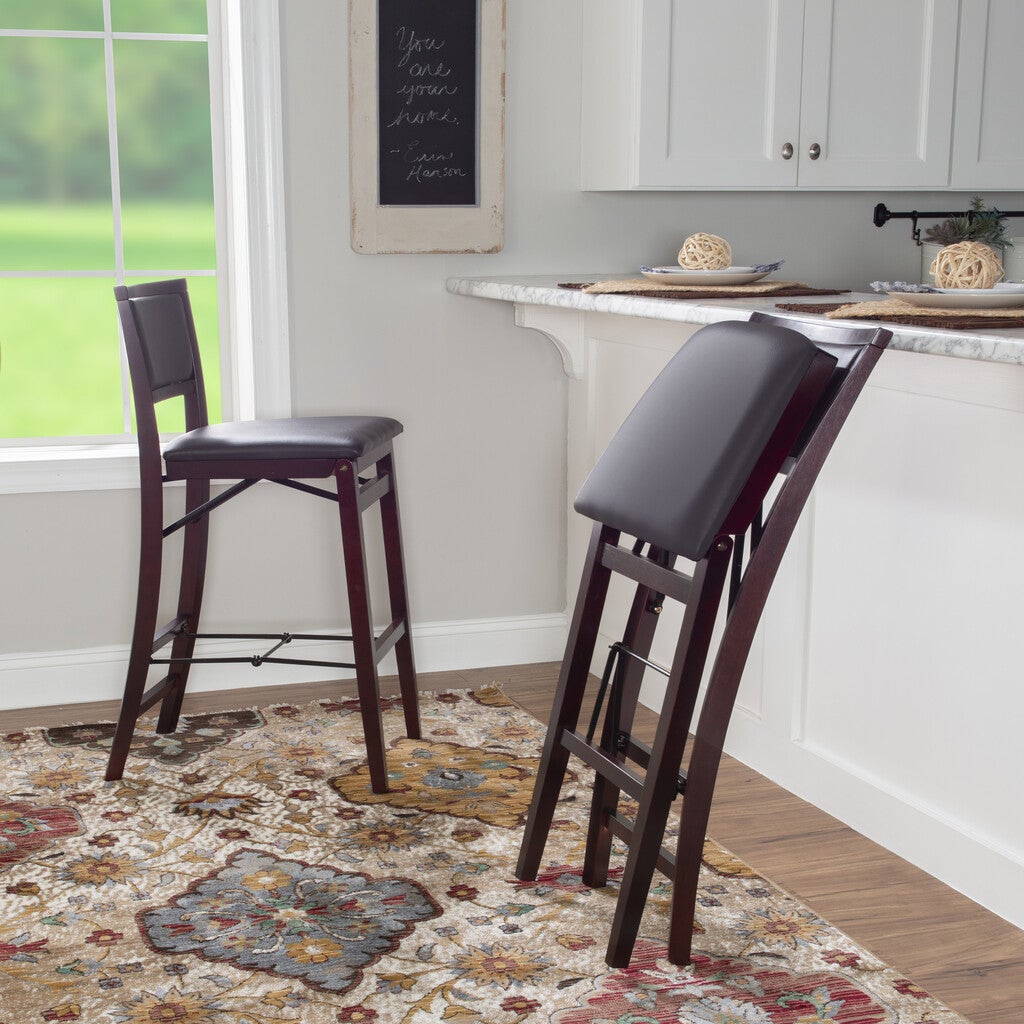 Two bar stools in a kitchen island scene with one stool pulled out.