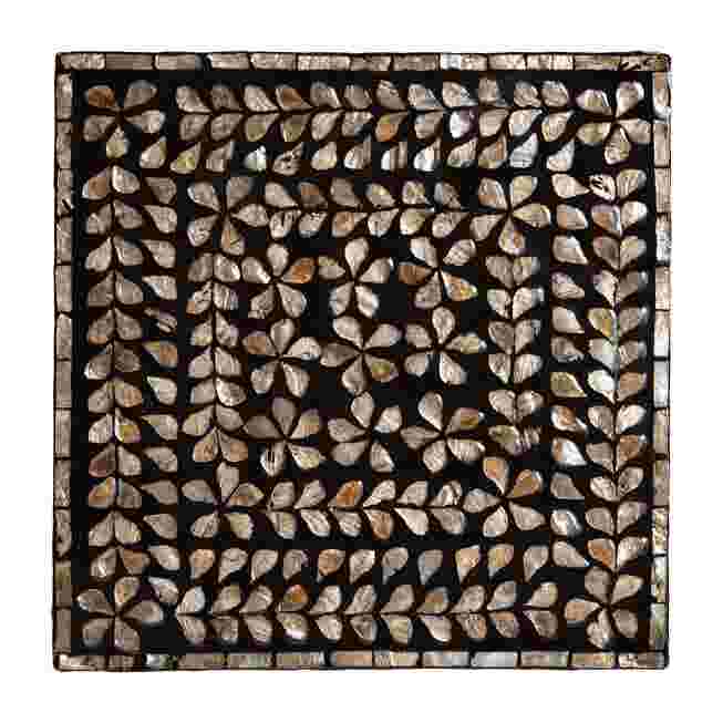 Top-down view of the mother of pearl inlay pattern on the end table.