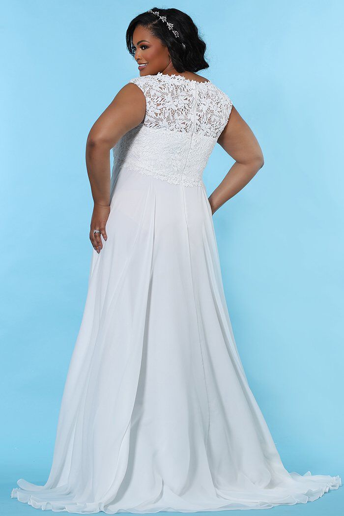 Woman within wedding shop dresses