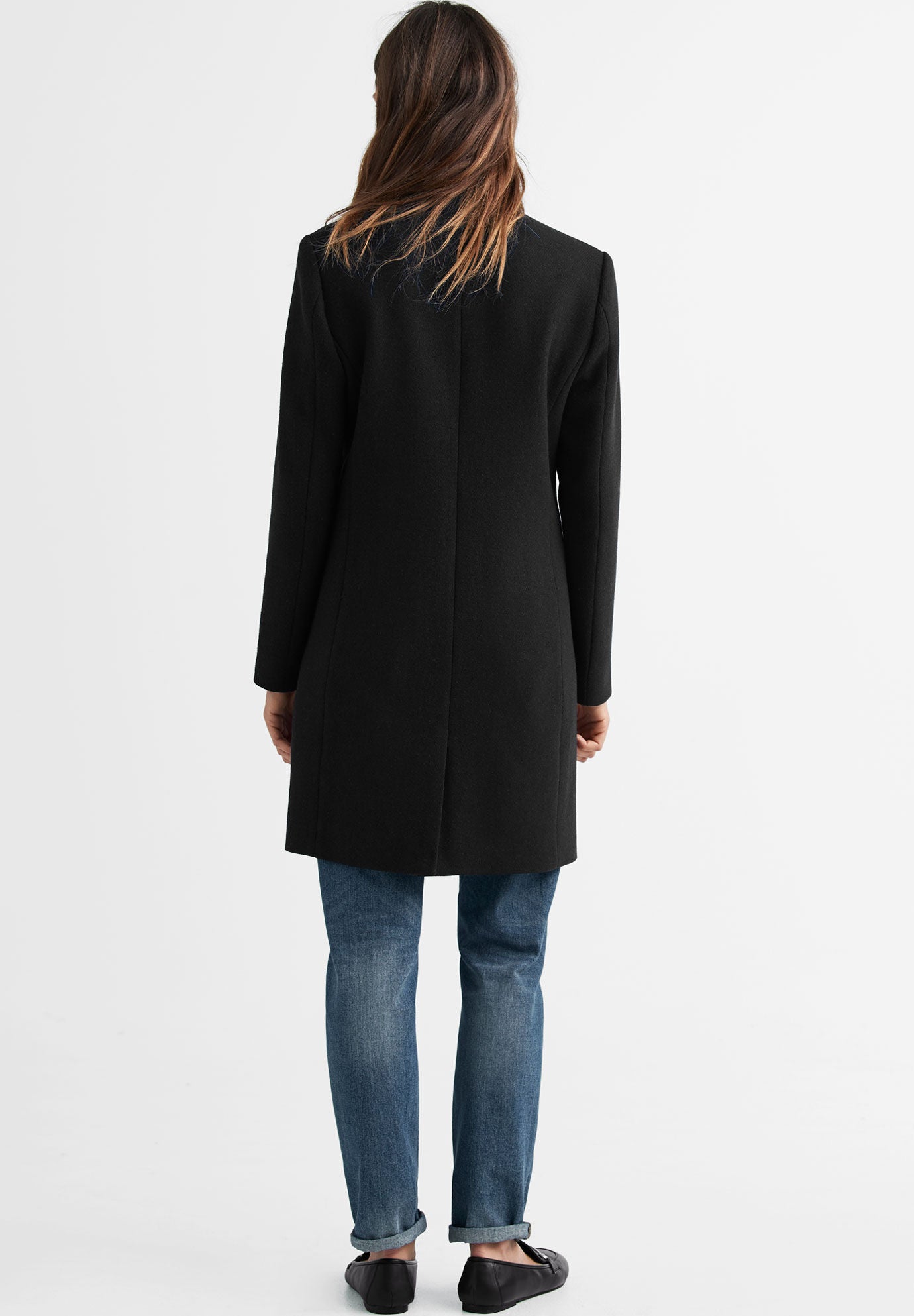 Woman within shop wool coats