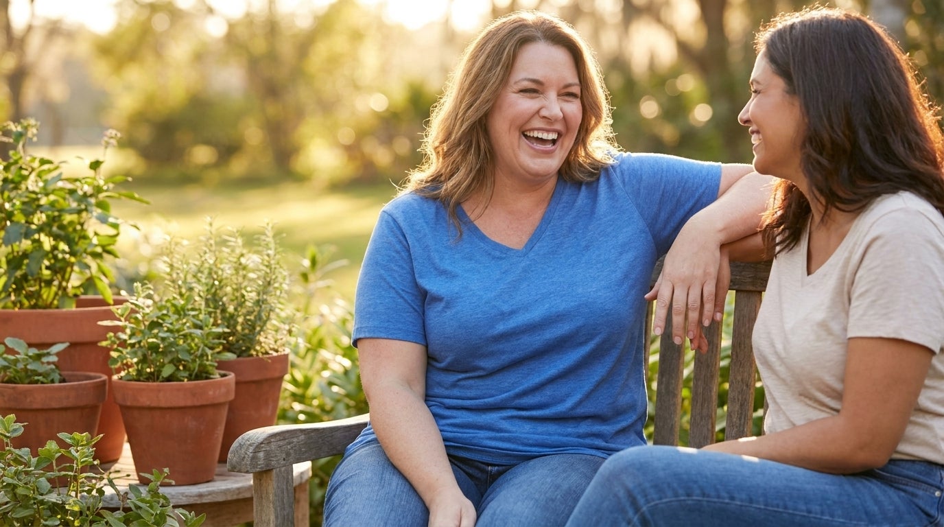 Woman in a heathered cotton V-neck tee laughing on a sunlit patio