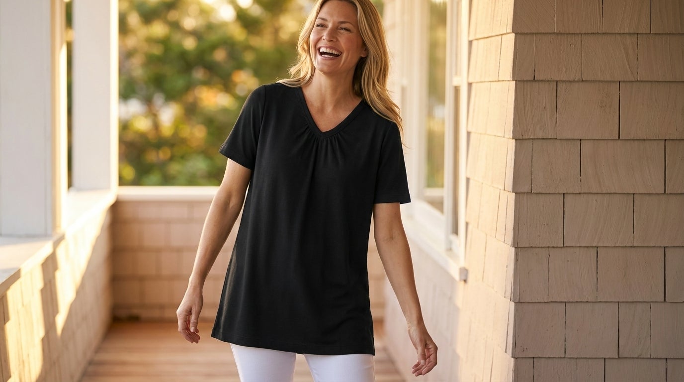Woman wearing a shirred V-neck knit tunic over pull-on capri pants on a sunlit porch
