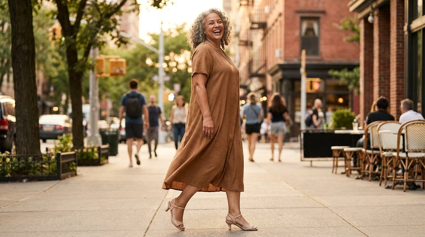 Woman in wide-width kitten heel sandals walking confidently on a sunlit street