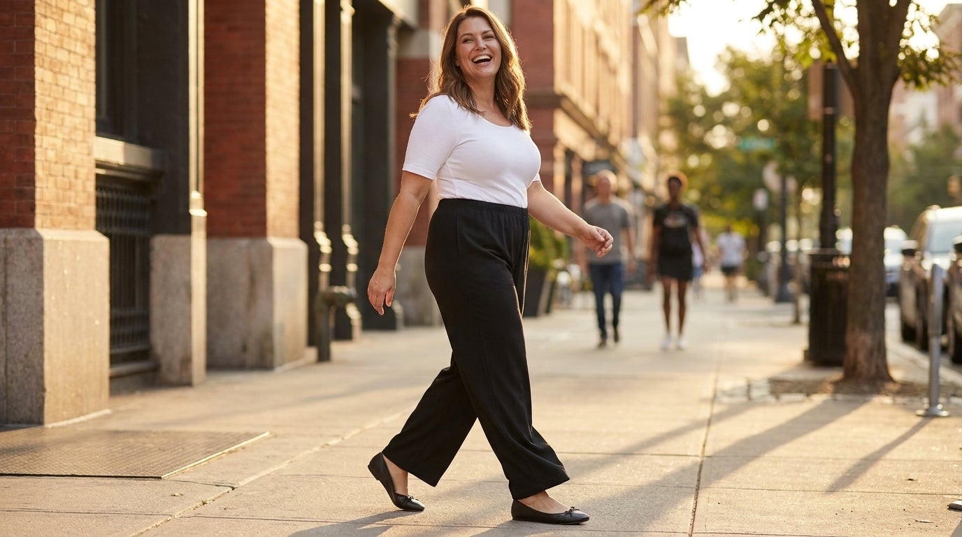 Woman walking outdoors in wide-leg knit pants that drape past the calf