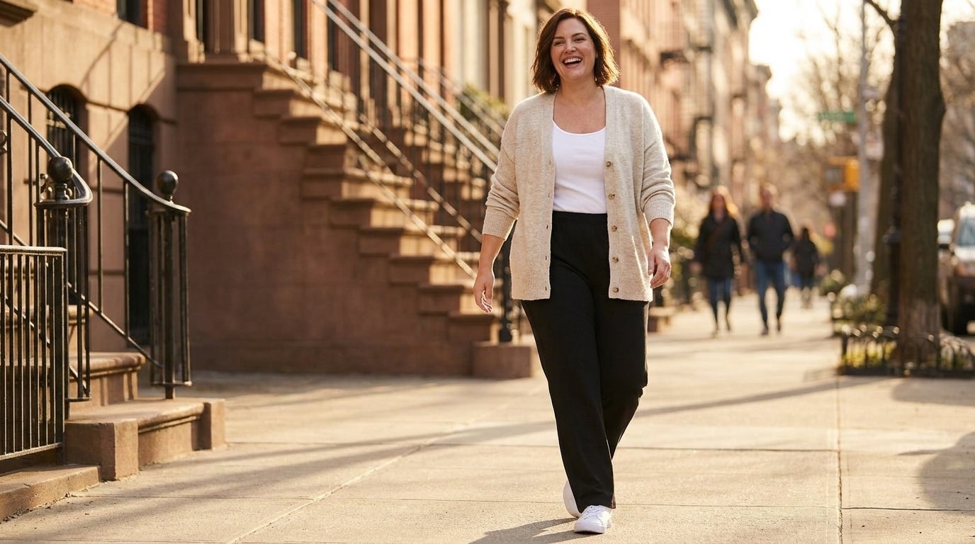Woman in a stretchy knit straight-leg pant with a full elastic waistband, walking outdoors