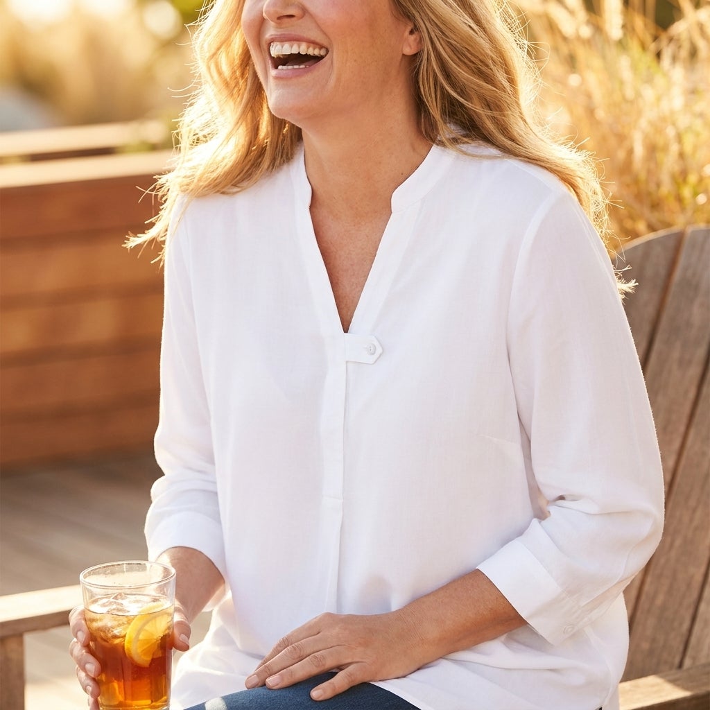 Woman wearing a rayon tab-front blouse with a mandarin collar on a sunlit patio